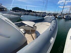 Interior view of a spacious boat featuring comfortable seating and a table, perfect for relaxing while docked at the marina.