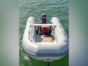A clear view of a small inflatable boat with an outboard motor, perfect for quick trips on the water.