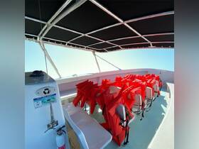 Interior view of a boat featuring seating equipped with bright red life jackets, providing safety and comfort for passengers. Ideal for ensuring a secure boating experience.