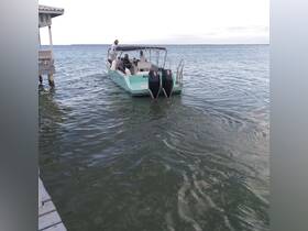 A group of people aboard a boat in calm waters, showcasing a perfect day for on-water activities and exploration.