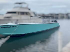 A striking view of the 'Nautical Star' boat docked, showcasing its vibrant turquoise color and sleek design, perfect for day trips on the water.