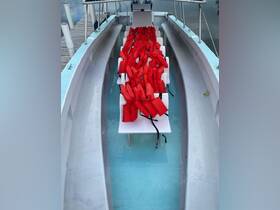Interior view of a boat showcasing neatly arranged life jackets on seating, emphasizing safety measures for passengers.