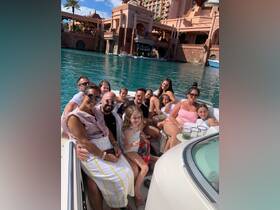 A joyful family gathers on a boat, enjoying their time together in a beautiful waterfront setting — perfect for memorable celebrations and family outings.
