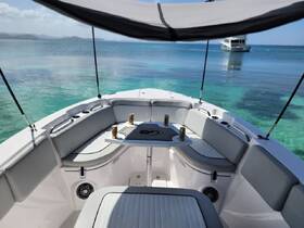 A well-appointed boat interior featuring comfortable seating and a shaded area, perfect for relaxing while enjoying the stunning turquoise waters.