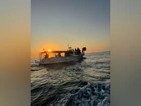 A lively group enjoys a sunset cruise aboard a boat, creating a perfect backdrop for memorable moments on the water.