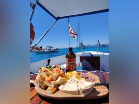 A beautifully arranged platter of snacks and drinks on a boat, perfect for enjoying a relaxing day on the water with friends or family.