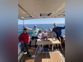 A joyful group of friends and family gather on a boat, enjoying their time together on the water — perfect for memorable outings and celebrations.