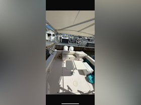 Interior view of a boat's seating area, featuring a table and helm, perfect for relaxing and enjoying the ride.