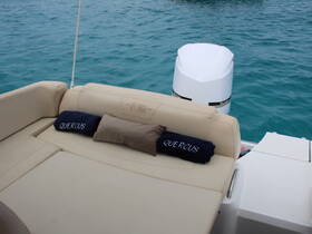 A cozy seating area on a boat featuring plush cushions, perfect for relaxing while enjoying the turquoise waters.