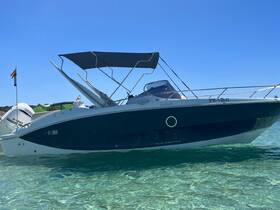 A sleek speedboat anchored in crystal-clear waters, showcasing its elegant design and inviting atmosphere for a day on the water.