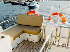 A cozy seating area inside a boat, featuring plush cushions and a stylish design, perfect for relaxing while enjoying the water.