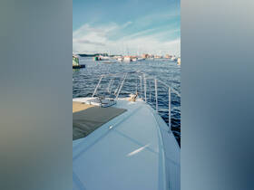 A stunning view from the front of a yacht, showcasing the serene waters and nearby boats, perfect for a day of relaxation on the water.