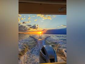 A stunning sunset view from the back of a boat, showcasing the tranquil waters and vibrant colors of the sky — perfect for evening cruises.