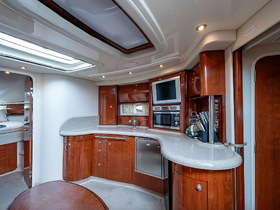 A beautifully designed interior of a boat's kitchen area, featuring modern amenities and elegant wood finishes, perfect for onboard dining and relaxation.