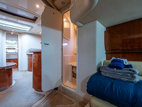 Interior view of a boat cabin featuring a bathroom and seating area, showcasing the comfortable amenities available for guests.