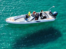 A group of friends enjoys a day on the water aboard a sleek boat, showcasing the vibrant turquoise sea beneath them — perfect for adventure and exploration.