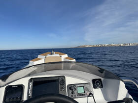 A view from the helm of a boat, showcasing the console and dashboard as it navigates through open waters, perfect for boating enthusiasts.