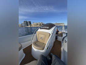 A view of the interior seating area of a boat, featuring a comfortable helm and stylish design, perfect for a day on the water.