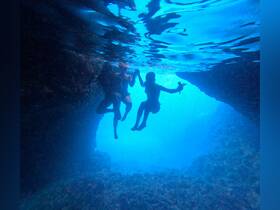 Three friends enjoy an exhilarating underwater experience, exploring a beautiful marine environment — perfect for adventure seekers and snorkeling enthusiasts.
