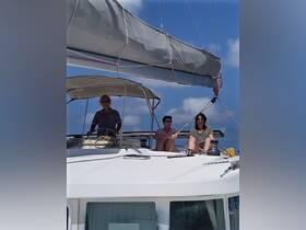 A group of friends relaxes on the deck of a sailboat, enjoying the sun and sea breeze — a perfect moment for sailing enthusiasts.
