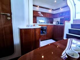 A well-appointed interior of a boat featuring a modern kitchen area and elegant wood finishes, perfect for comfortable cruising.