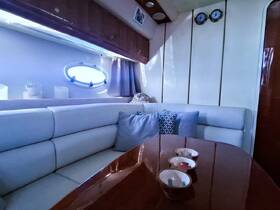 Cozy interior of a boat cabin featuring comfortable seating and a polished dining table, perfect for relaxing during your nautical adventures.