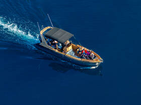 A lively group enjoys a day on the water aboard a sleek boat, showcasing the thrill of adventure and camaraderie on the open sea.