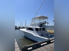 A sleek yacht docked at the marina, showcasing its elegant design and spacious layout, perfect for fishing trips or leisurely cruises.