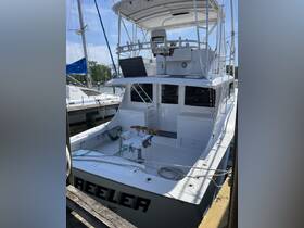 A detailed view of the helm area inside a fishing boat, showcasing the console and seating arrangements, perfect for anglers looking for a comfortable fishing experience.