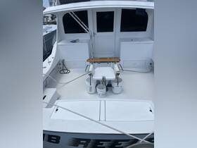 Interior view of a boat's helm area, showcasing the console and seating arrangements, ideal for fishing or cruising.