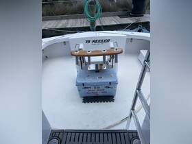A well-equipped helm area of a fishing boat featuring a YETI cooler and fishing gear, perfect for a day out on the water.