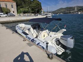 A sleek speedboat docked at the marina, showcasing its modern design and powerful Honda engine, perfect for exploring coastal waters.