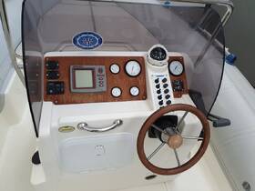 A detailed view of the helm and control console inside a boat, showcasing essential navigation instruments and controls for a smooth sailing experience.