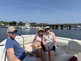 A cheerful group of friends enjoys a day on the water aboard a boat, perfect for creating lasting memories and celebrating together.