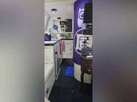 Interior view of a boat's cabin featuring a compact kitchen area, showcasing the functional design and amenities available for onboard living.