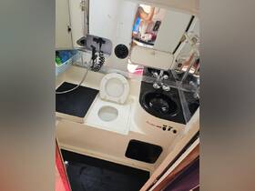 Interior view of a boat's bathroom featuring a toilet and sink area, showcasing the practical amenities available on board.