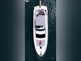 Aerial view of a yacht with a person sunbathing on the deck, showcasing a perfect day on the water — ideal for relaxation and leisure activities.