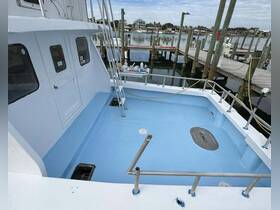 Interior view of a boat's helm area featuring a clean, blue deck and access points, ideal for showcasing the boat's layout and design.