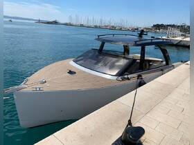 A sleek yacht docked at the marina, showcasing its modern design and elegant lines against the tranquil waters.