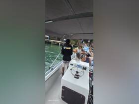 Guests enjoy a lively moment aboard a boat, engaging with the crew and each other — perfect for group outings and celebrations on the water.