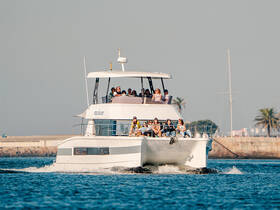 A lively group enjoys a day out on a yacht, showcasing the perfect setting for celebrations and social gatherings on the water.
