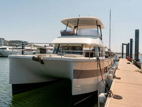 A stunning catamaran docked at the marina, showcasing its sleek design and spacious layout, perfect for luxury cruising.