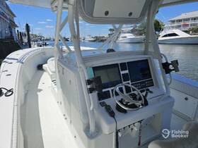 A detailed view of the helm and console area inside a boat, showcasing modern navigation equipment and comfortable seating — ideal for boating enthusiasts and captains.