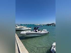 A sleek speedboat docked in clear turquoise waters, showcasing its modern design against a backdrop of other boats.