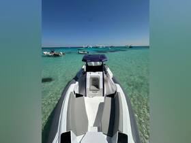 A sleek speedboat anchored in crystal-clear waters, surrounded by other vessels — perfect for a day of adventure on the water.