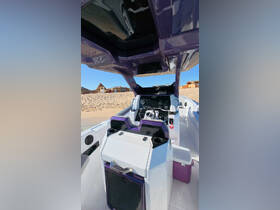 A sleek view of the helm and console area inside a modern boat, showcasing its stylish design and functional layout.