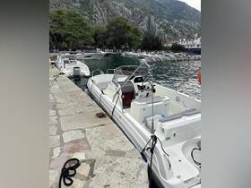 A sleek speedboat docked at a picturesque marina, surrounded by lush greenery and rocky mountains, perfect for exploring coastal waters.