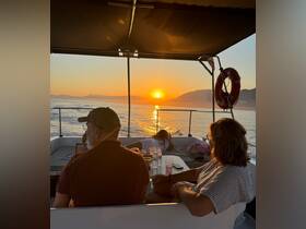 A group enjoys a stunning sunset aboard a yacht, creating a perfect backdrop for relaxation and celebration on the water.