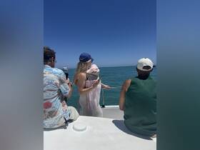 A group of friends enjoys a sunny day on the boat, taking in the beautiful ocean views — perfect for a memorable day out on the water.