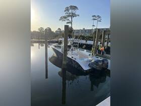 A sleek fishing boat docked at the marina, showcasing its powerful Yamaha engines and ready for a day on the water.